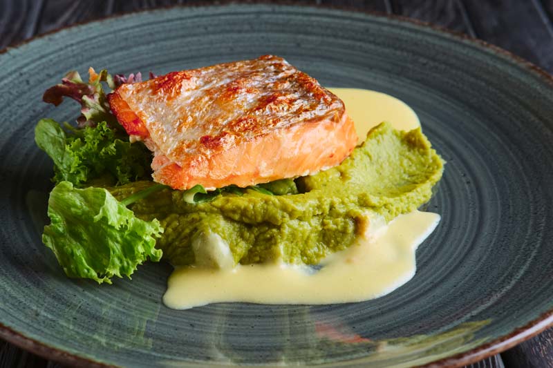 Superfood diet picture: Salmon with avocado salsa on a plate