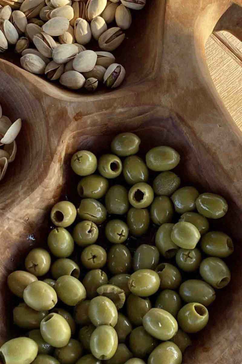 picture of various types of olives inside of a crate