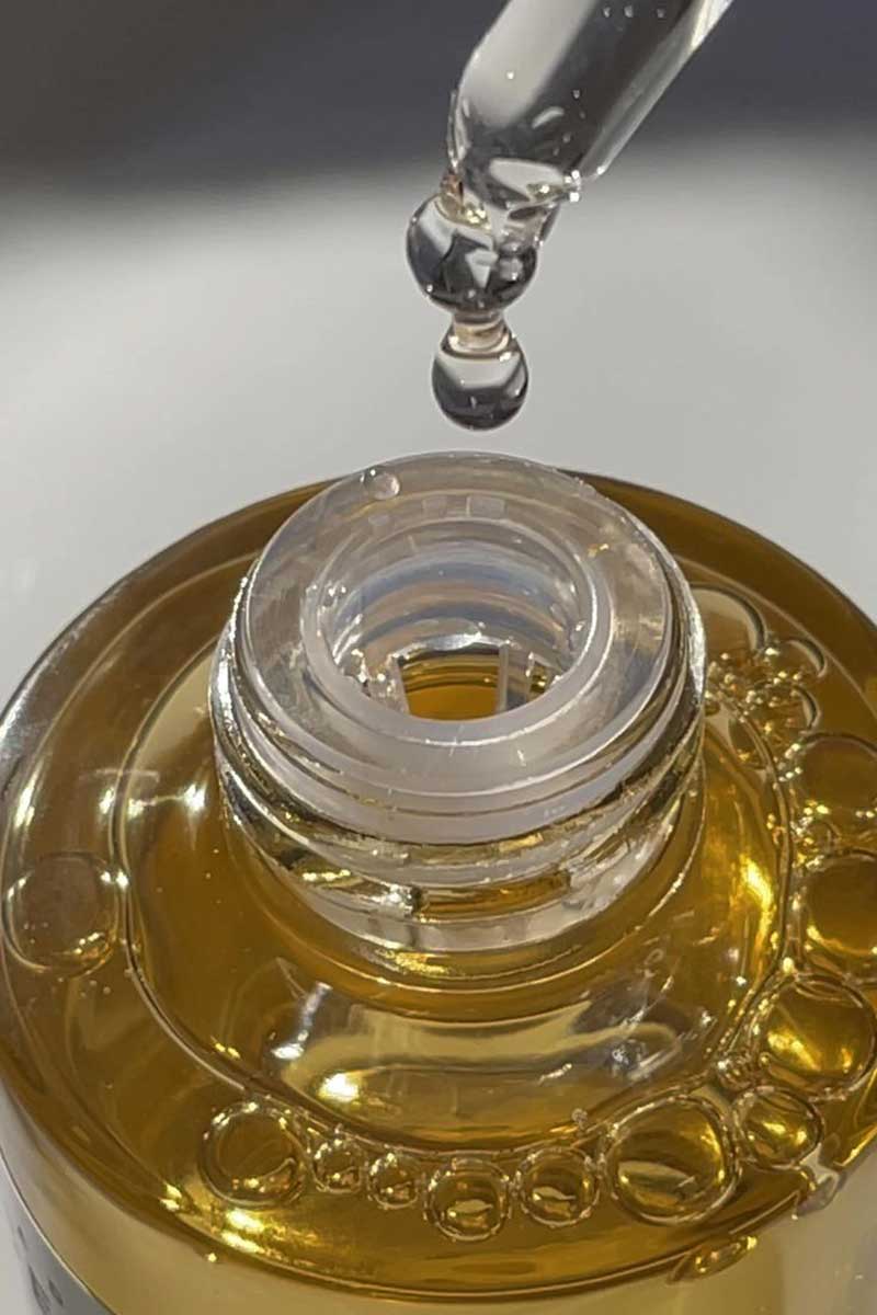 Bakuchiol based facial oil being sampled out of a bottle